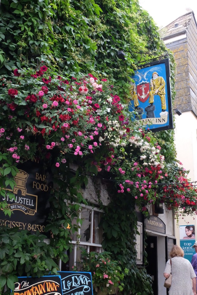 We love the flowers - in this case adorning a public house in Mevagissey.