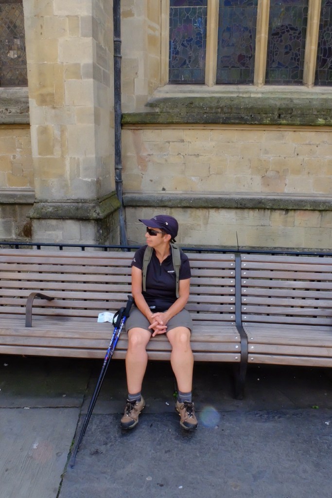 Ruth looking much shorter at the last seat on the trail, outside the Bath Abbey
