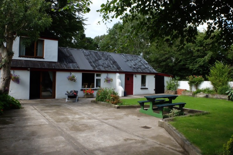 Ruth sunbathing outside the shed we are staying in.