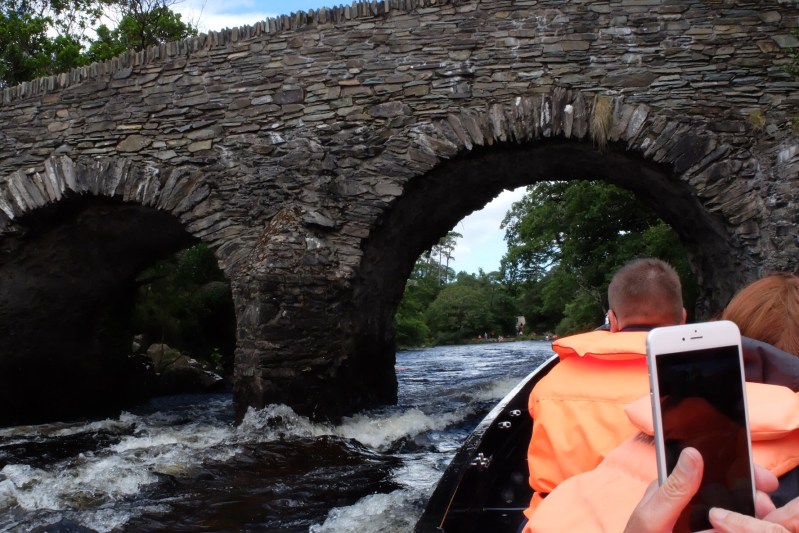 Shooting the rapids in a wooden boat